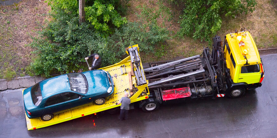 blue car in the towing truck