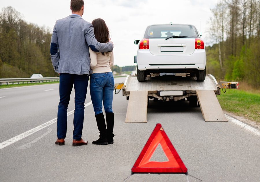 couples standing near the towing truck