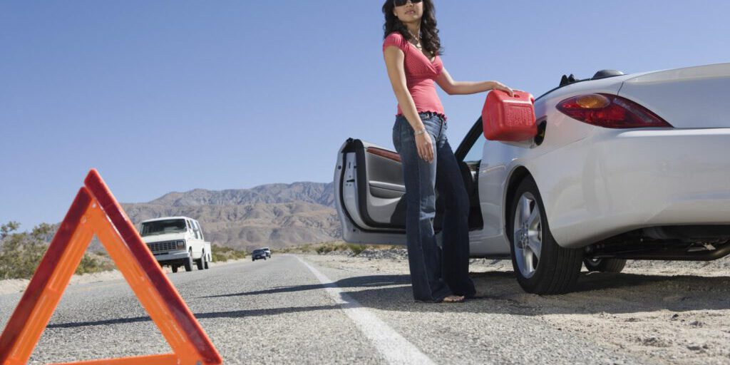 woman putting gasoline in her car